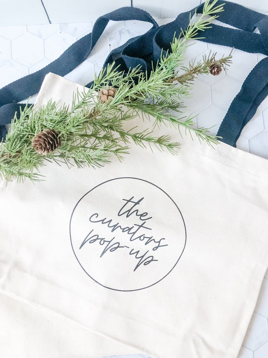 the curators pop-up tote bag